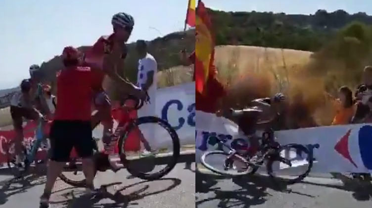 Šokujúci moment na Vuelte: Šialený divák skočil k cyklistovi a prehodil ho cez reklamnú bariéru! (VIDEO)